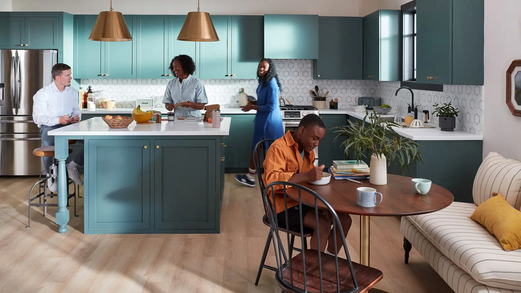 multiple people in blue kitchen
