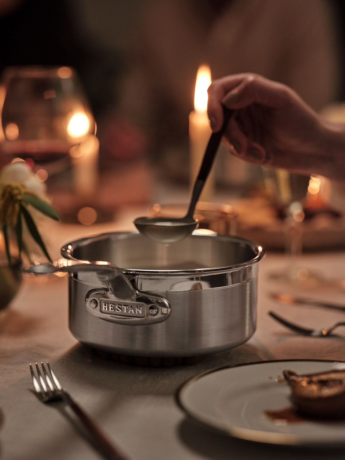 Serving pan on Candle-lit table with serving ladle 