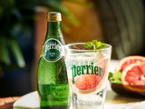 Perrier bottle with grapefruit in glass 