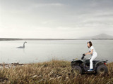 woman on 4 wheeler by water