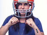 Person With Football Helmet And Blue Shirt