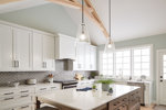 Large bright white kitchen with pendant lighting