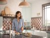 Person with food in checkered kitchen 