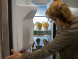 Person checking ice cream in freezer