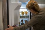 Person checking ice cream in freezer