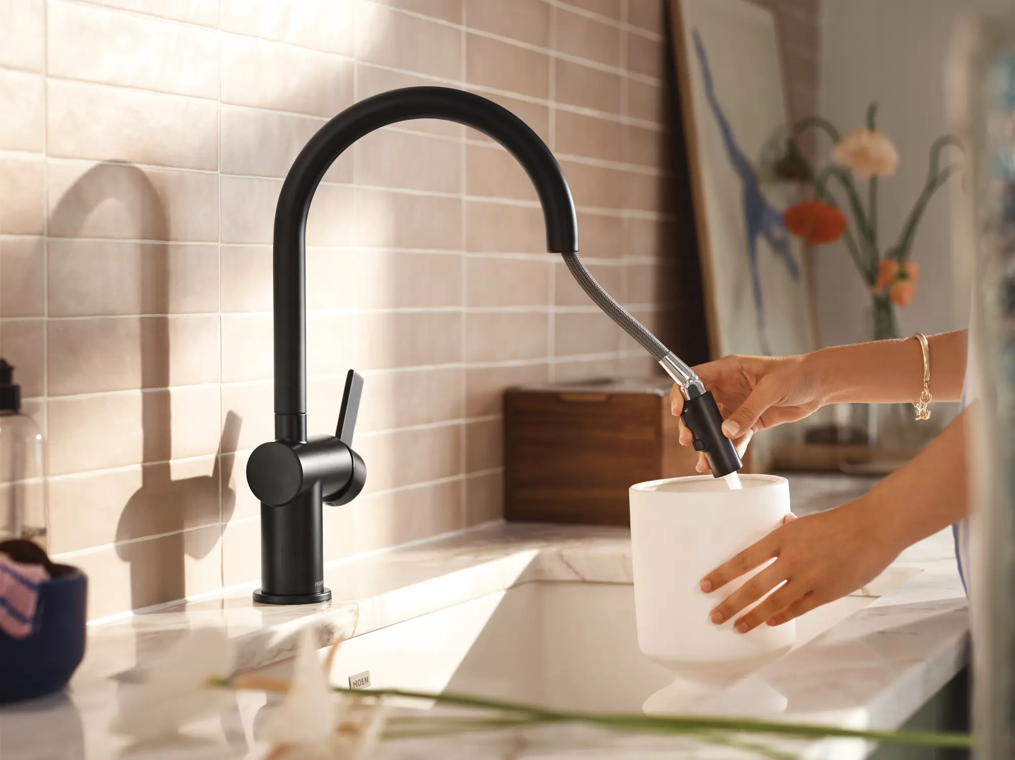woman using faucet attachement