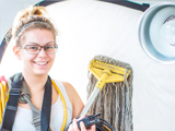 Person Holding Mop And Radio