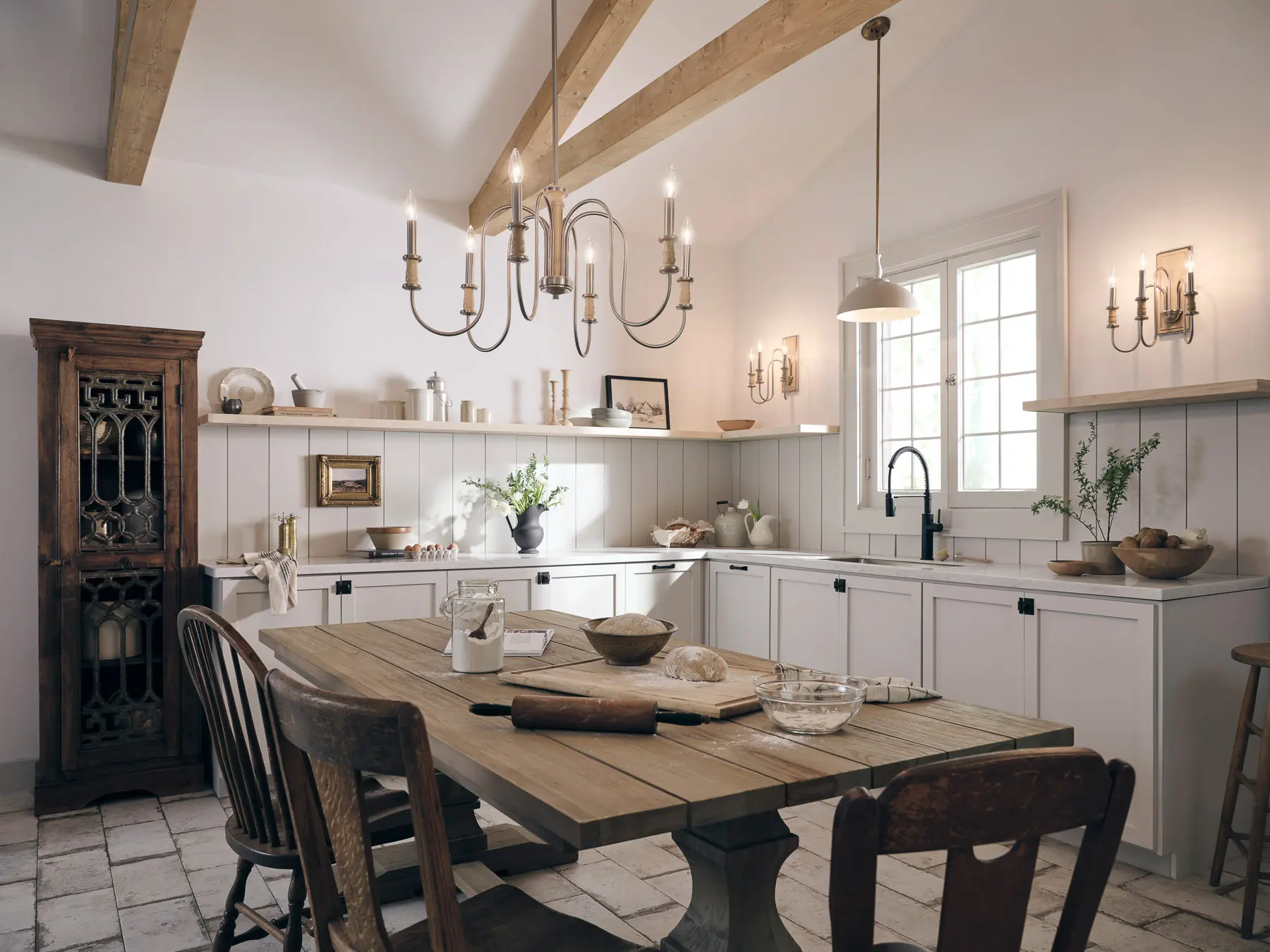 White kitchen with chandelier and table