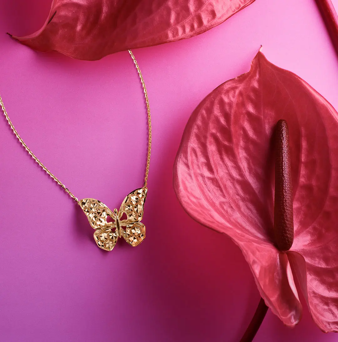 butterfly necklace on pink