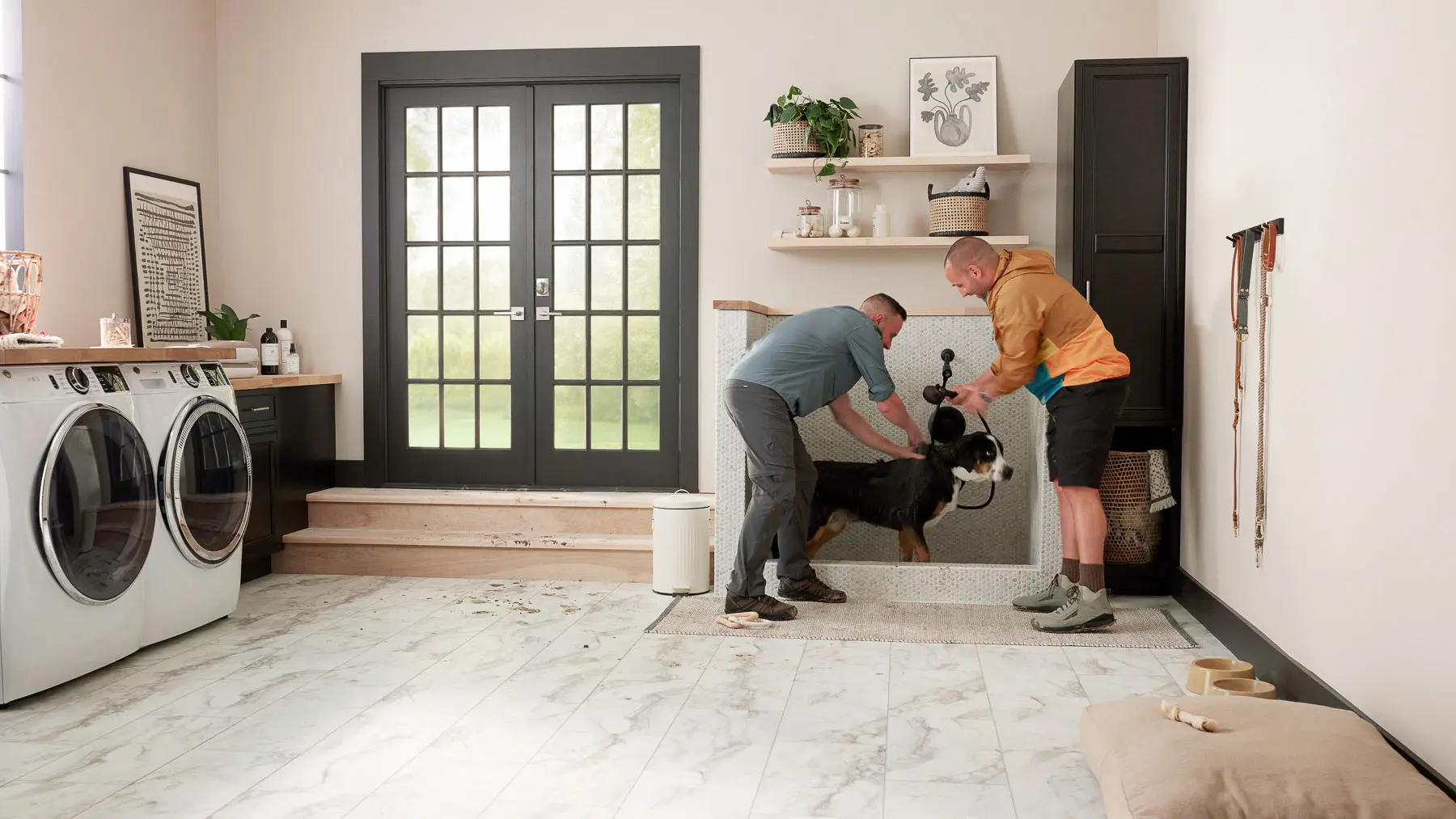 two men and a dog in laundry room