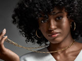 Curly hair person modeling necklace