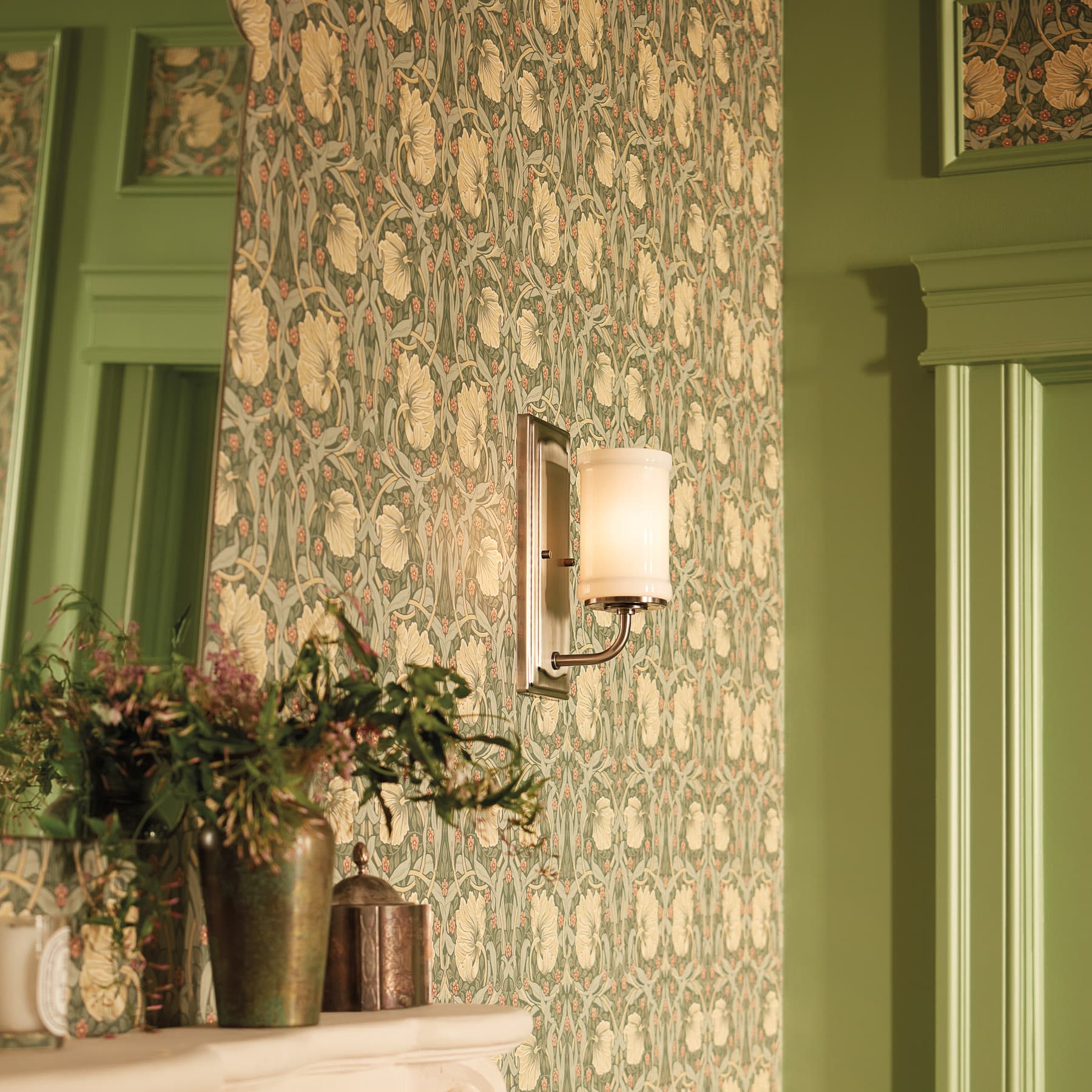 light sconce on green wallpaper