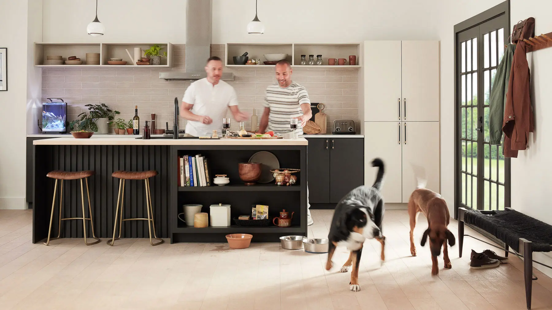 two men and dogs in kitchen