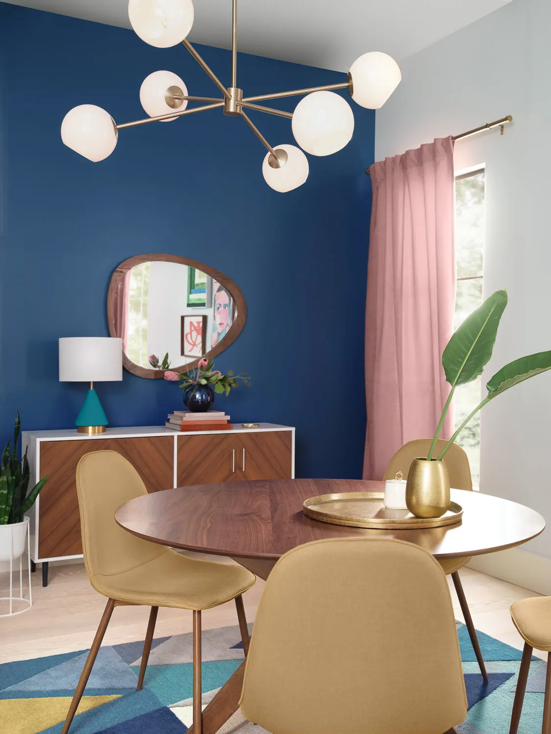 Midcentury modern Dining Room with mirror on the wall and dining room table