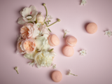 flowers and macaroons on a blush background