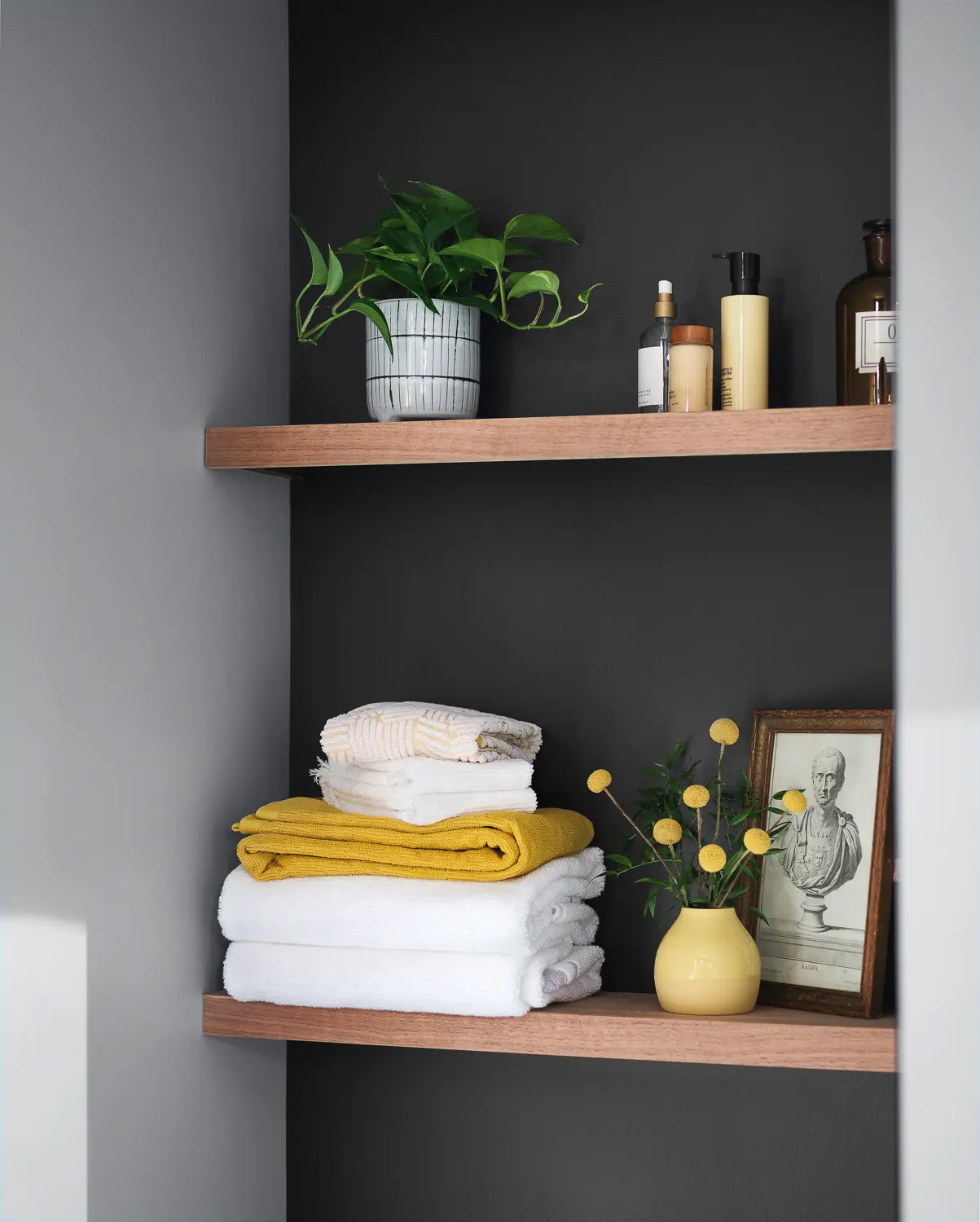 bathroom shelf with towels and decorative objects